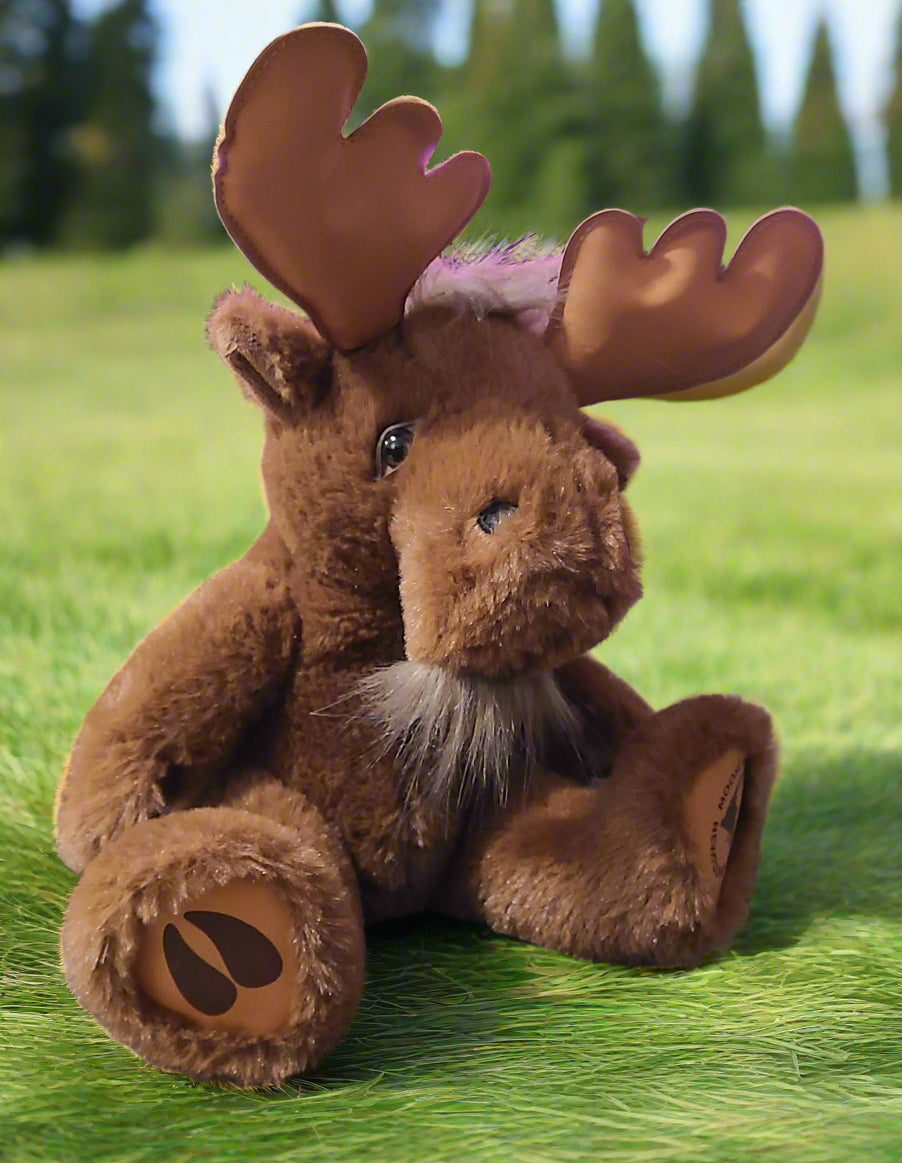 Majestic Plush Newfoundland Moose sitting in a grassy field