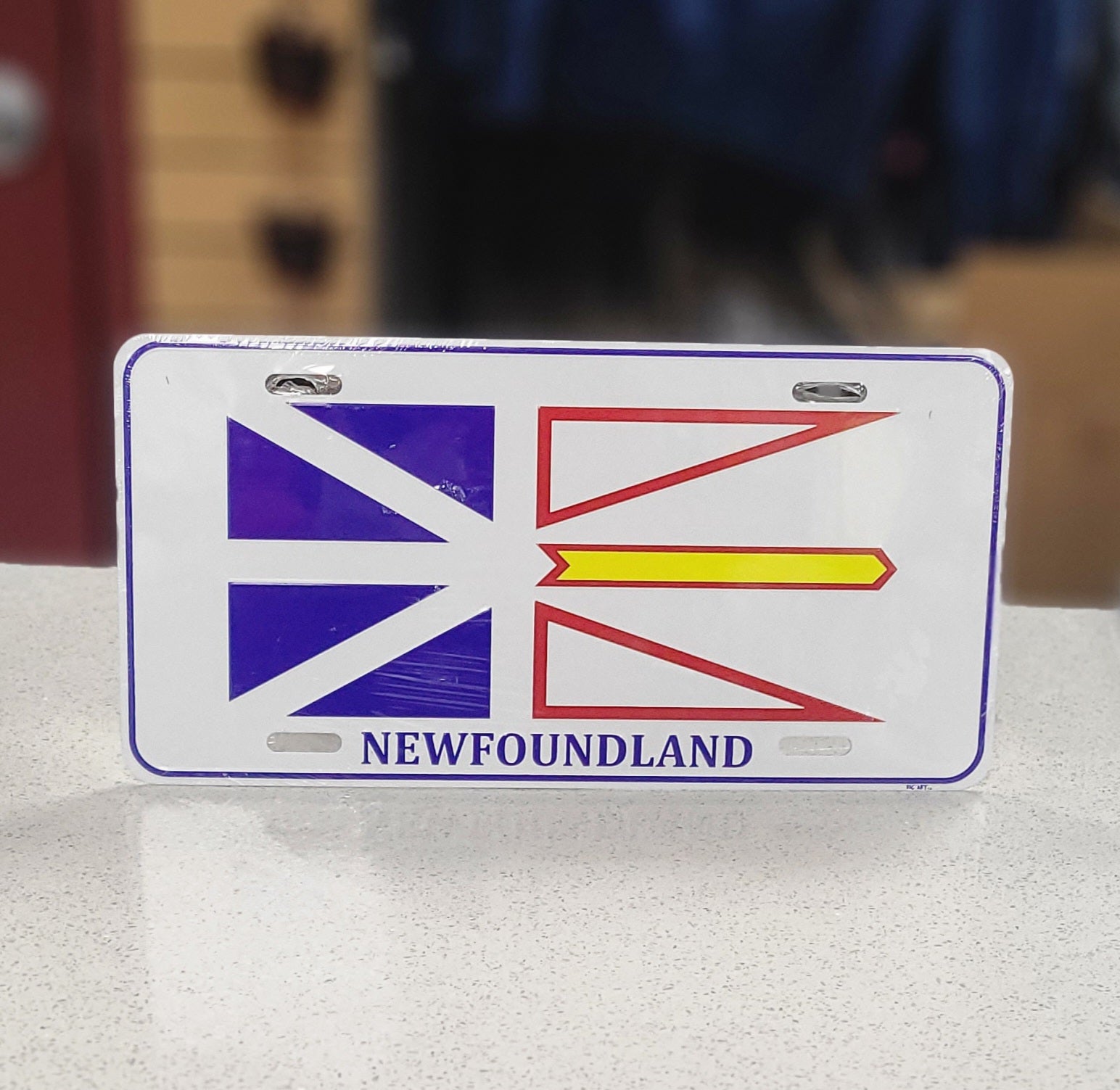 License plate with Newfoundland flag design on a white surface