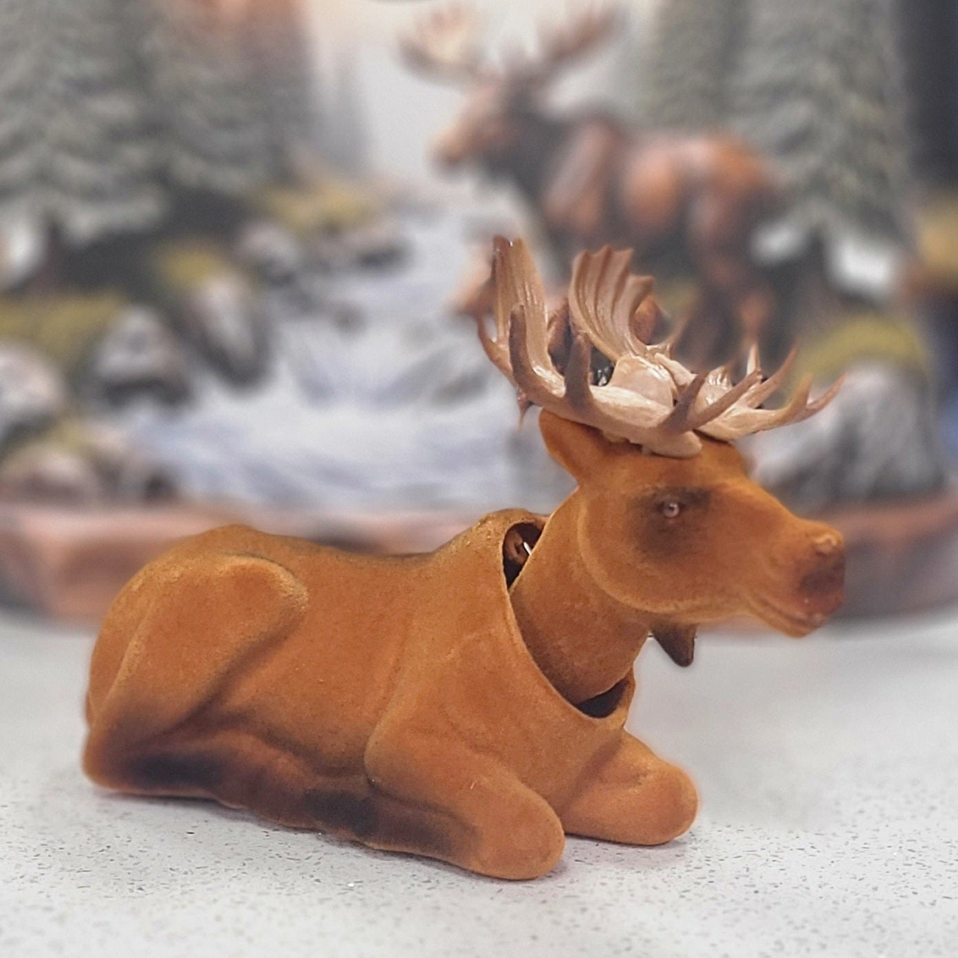 Moose bobble head figurine with blurry background