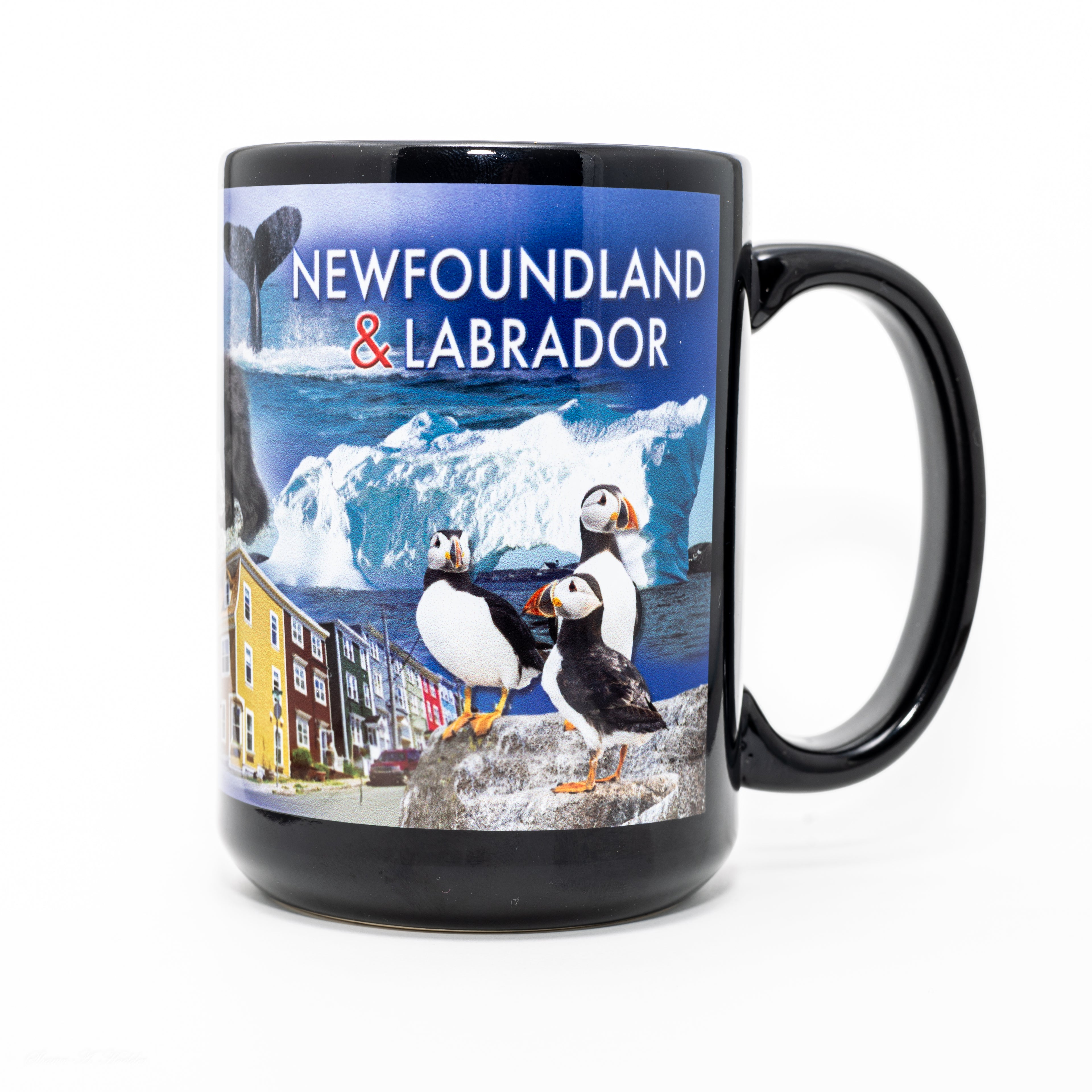 Newfoundland & Labrador souvenir mug featuring puffins, iceberg, whale tail, and colourful row houses, celebrating iconic local scenery.