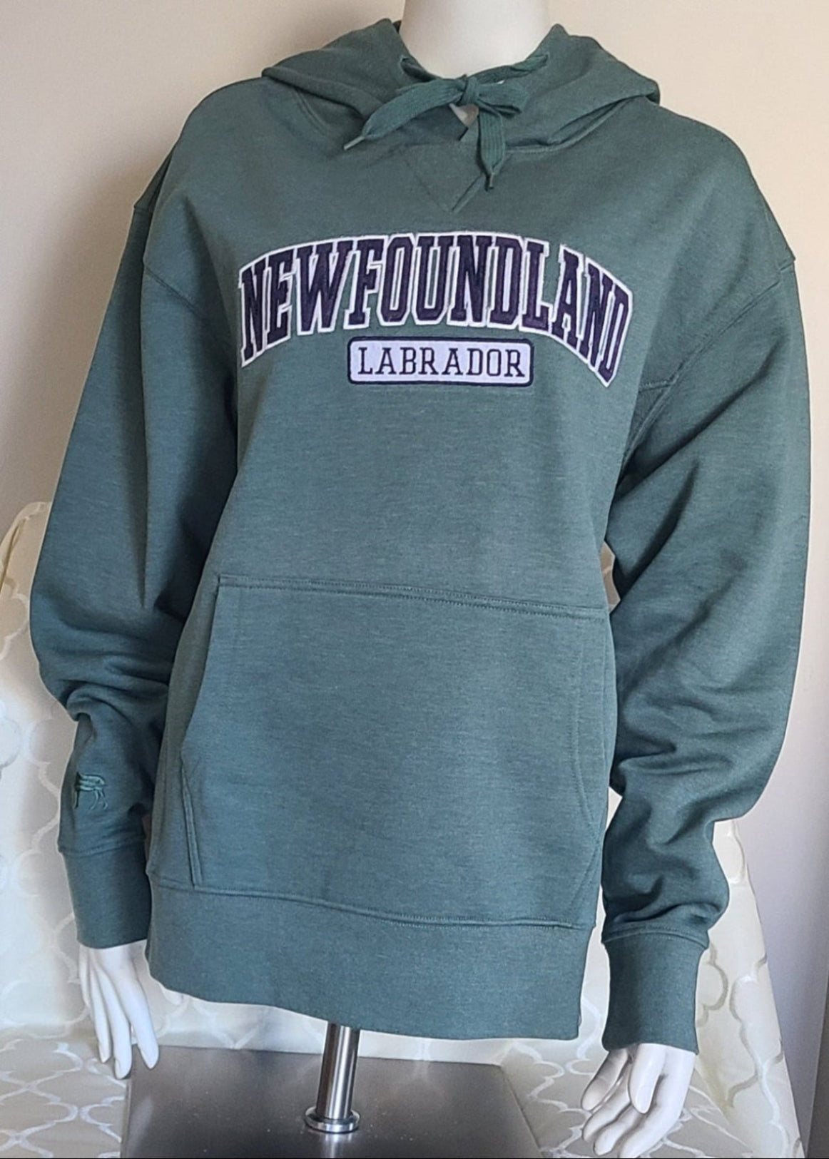 Green Newfoundland Labrador Hoodie on a Mannequin with a neutral background