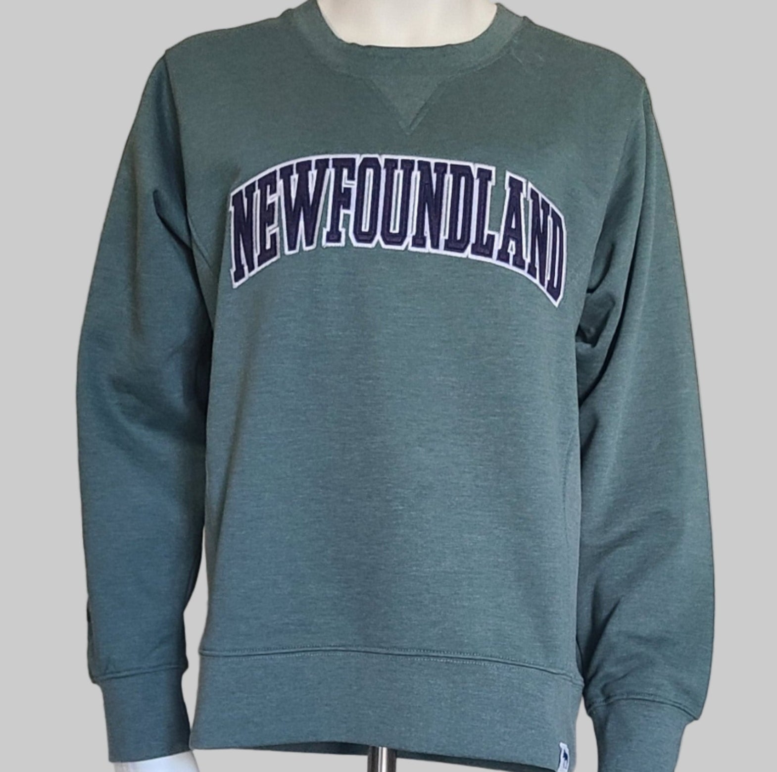 Green sweatshirt with Newfoundland text on a mannequin against a neutral background
