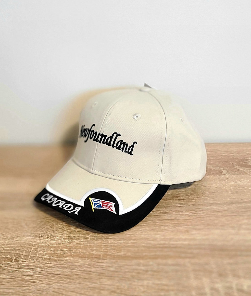 Beige cap with 'Newfoundland'  and Canada text and flag on a wooden surface