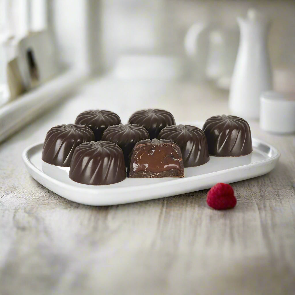 Rum-filled Newfoundland Screech Chocolates with one cut open to show creamy centre.