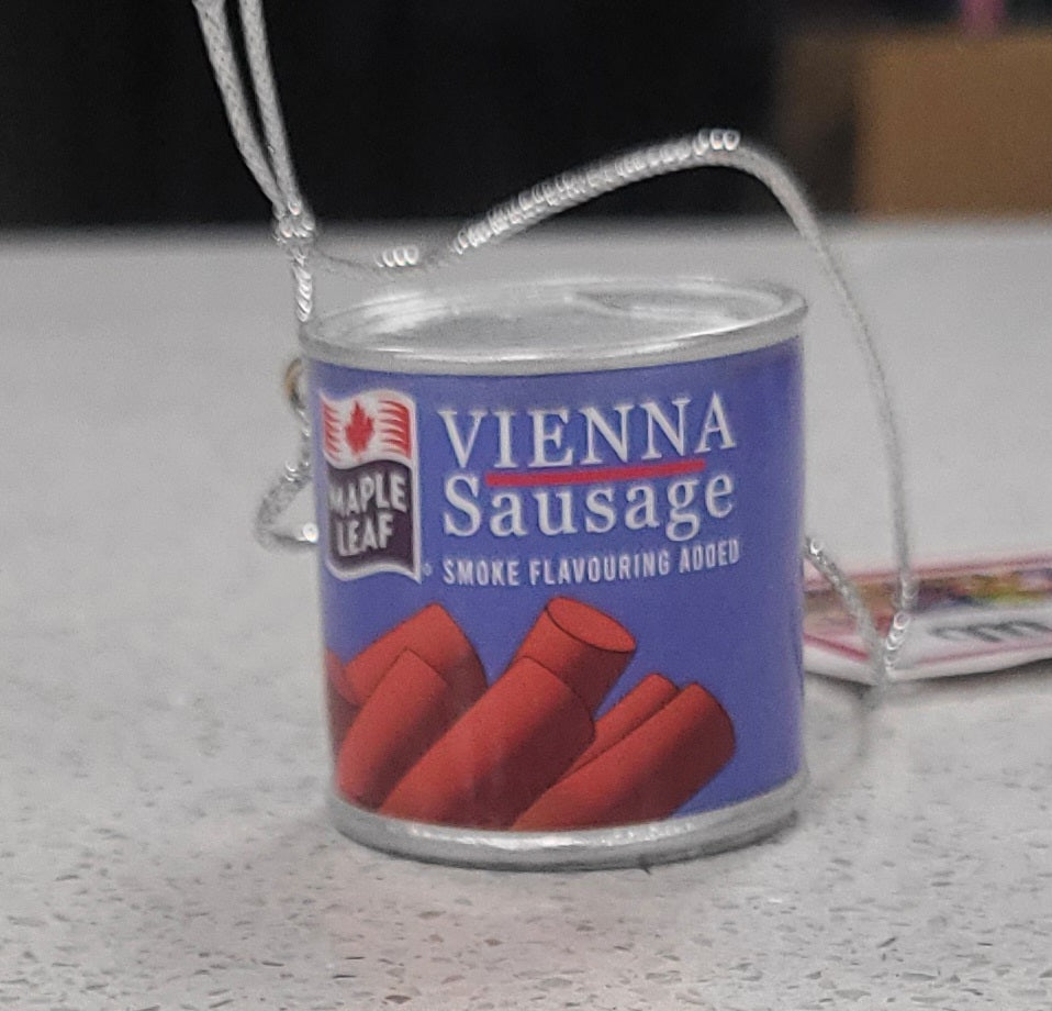 Miniature can of Vienna Sausage with a blue label on a light surface.
