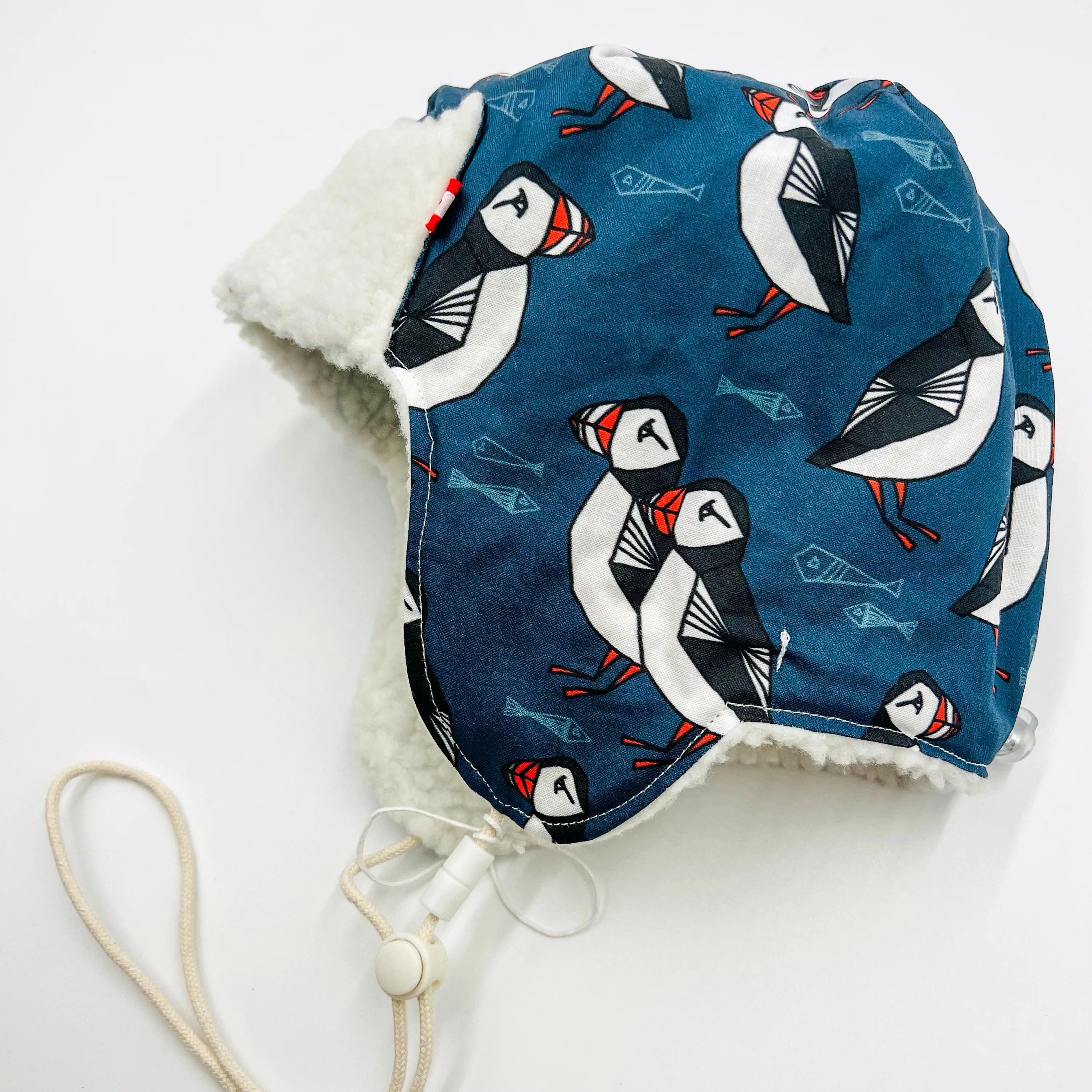 Baby Pilot Hat with Newfoundland puffin pattern on a white background