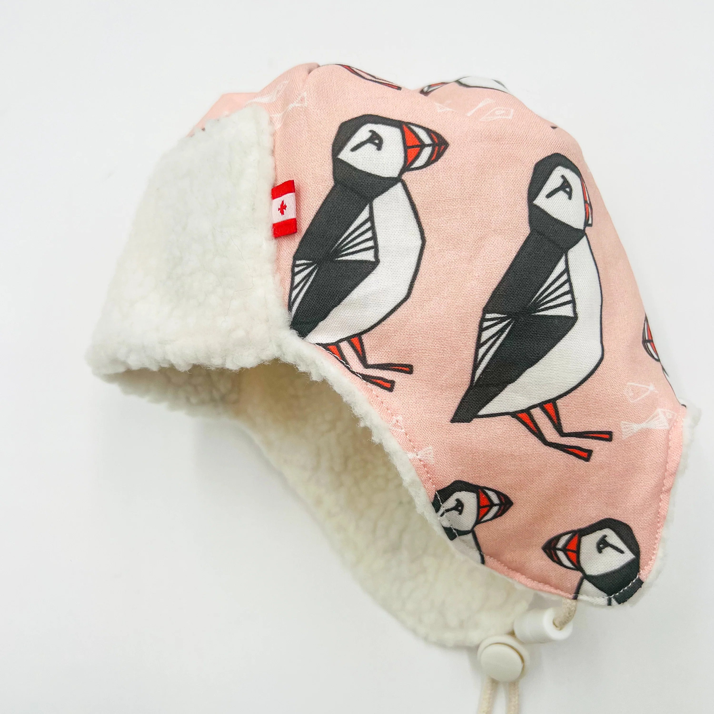 Side View Baby Pilot Hat  with Newfoundland puffin pattern on a white background
