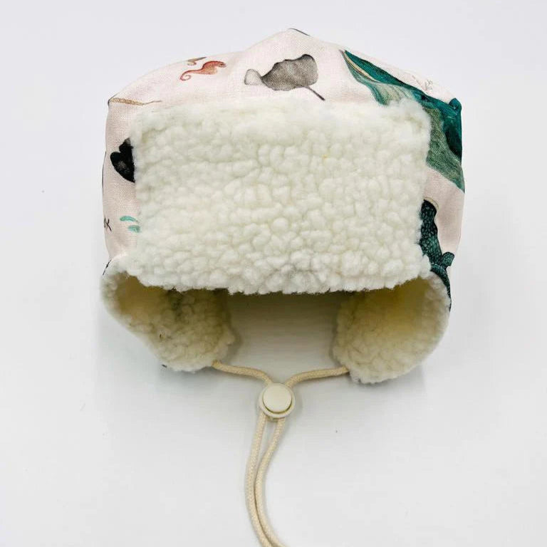 Front view of children's Pilot Hat with famous Newfoundland whale pattern and white fleece trim.