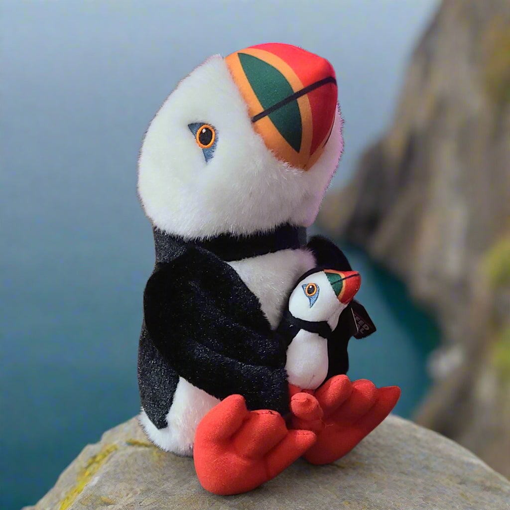 Plush Newfoundland Puffin sitting on a rock overlooking ocean