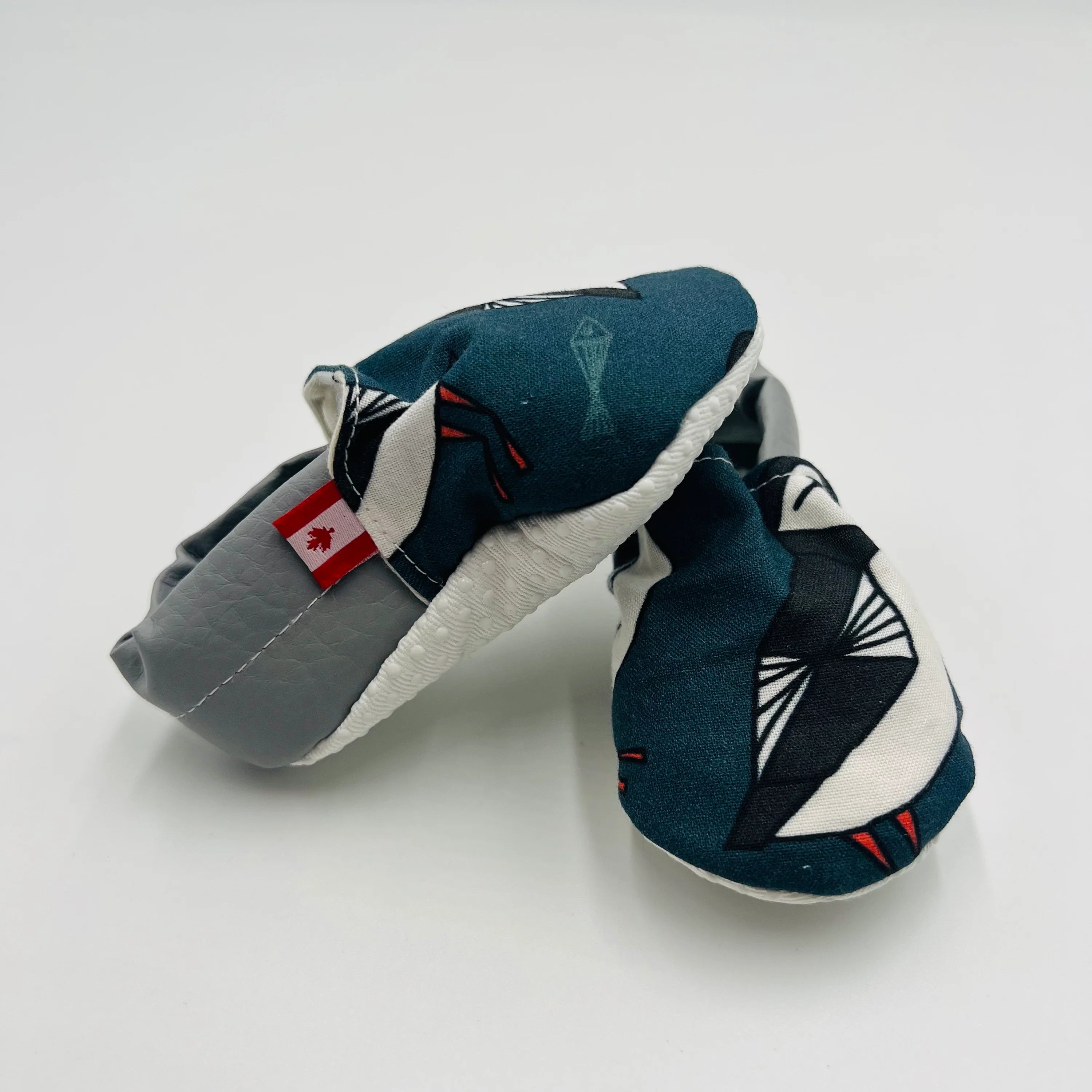 Navy Newfoundland puffin-print baby summer shoes with grey heel, anti-slip sole,  and Canadian flag tag.