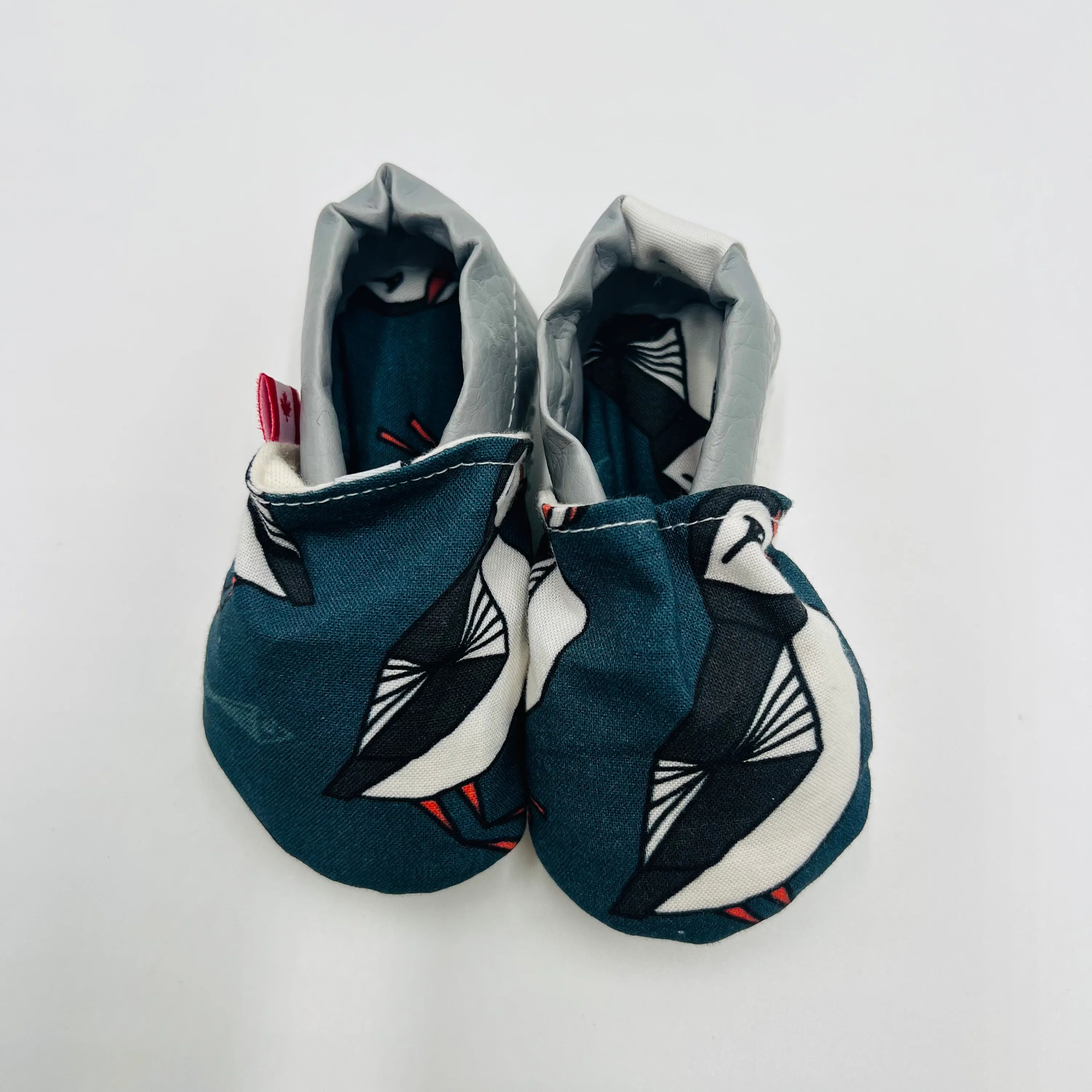 Navy Newfoundland puffin-print baby summer shoes with grey heel, front view.