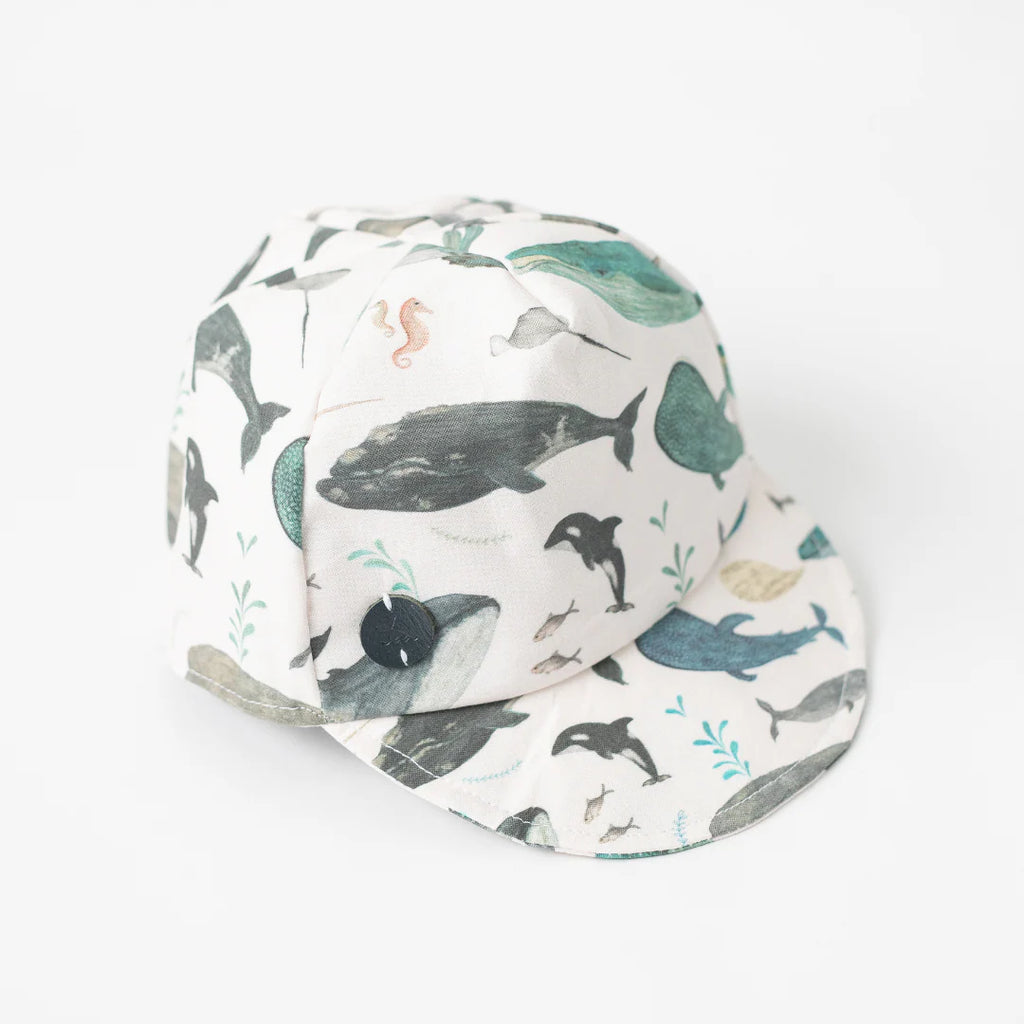 Toddler Whale Baseball Cap showing famous Newfoundland whales and narwhals, angled view.