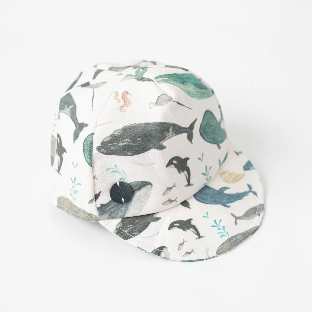 Toddler Whale Baseball Cap showing famous Newfoundland whales and narwhals, angled view.