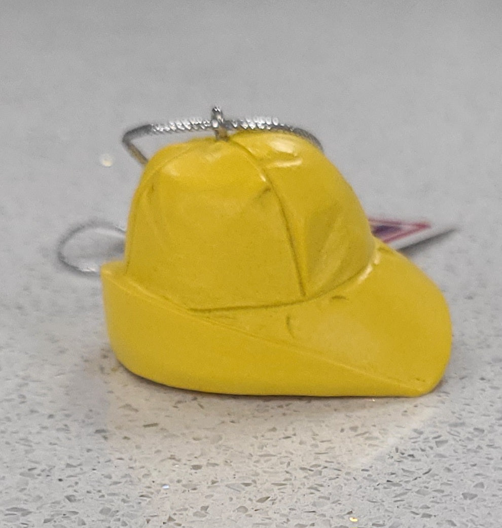 Yellow sou wester cap ornament on a gray surface