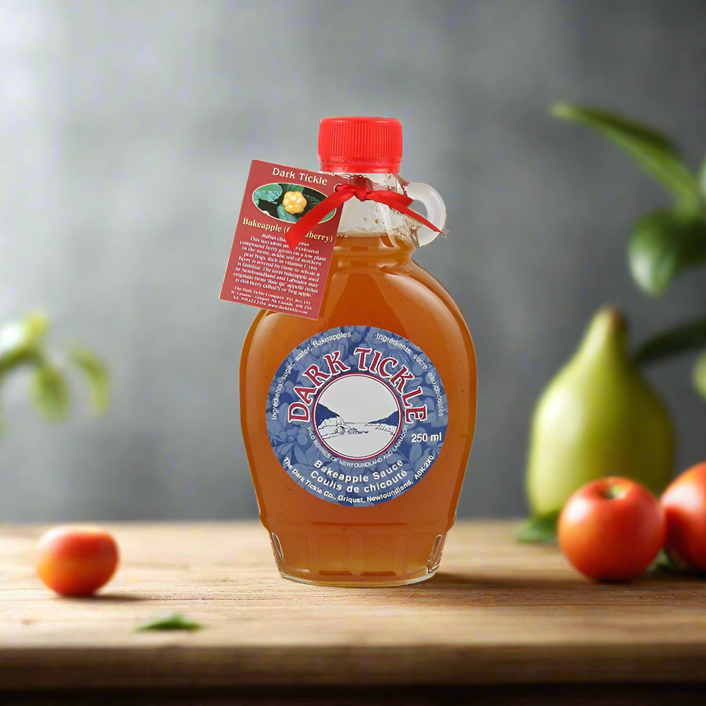 Bakeapple Sauce in 250 ml jug bottle with red cap, made in Newfoundland, on wooden countertop
