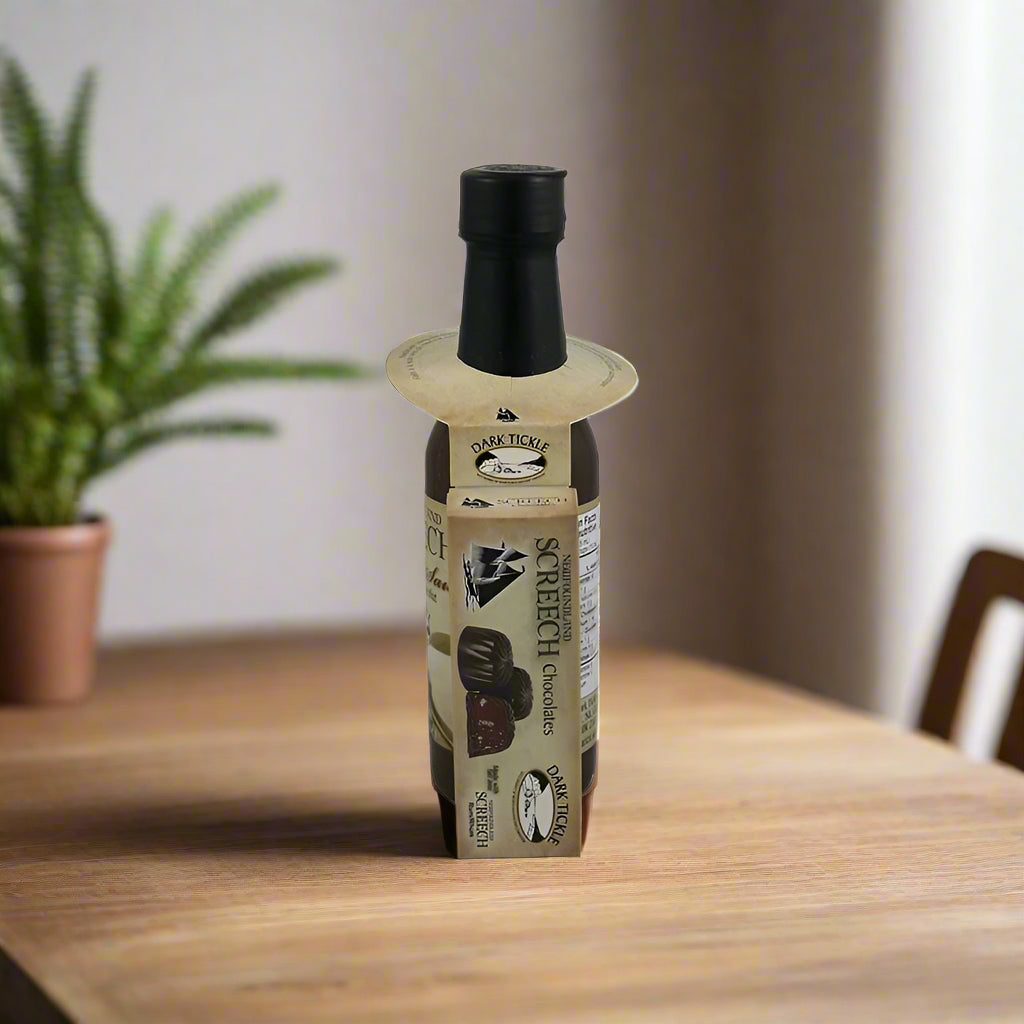Bottle of Newfoundland Screech Chocolate Sauce with Screech cocholate a wooden table with a blurred background