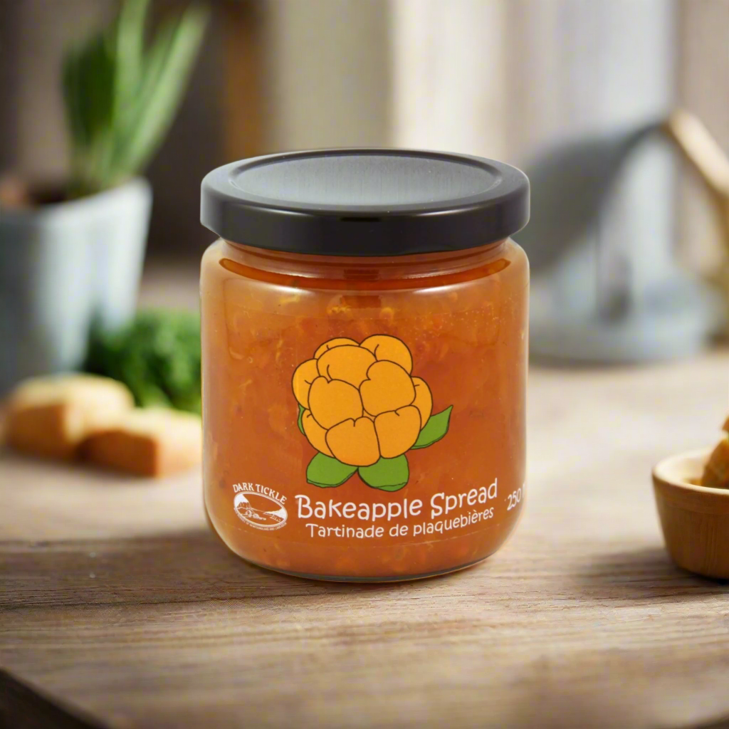 Jar of Old Fashioned Bakeapple Spread, a Newfoundland cloudberry delicacy in 250 ml glass jar on a wooden kitchen table.