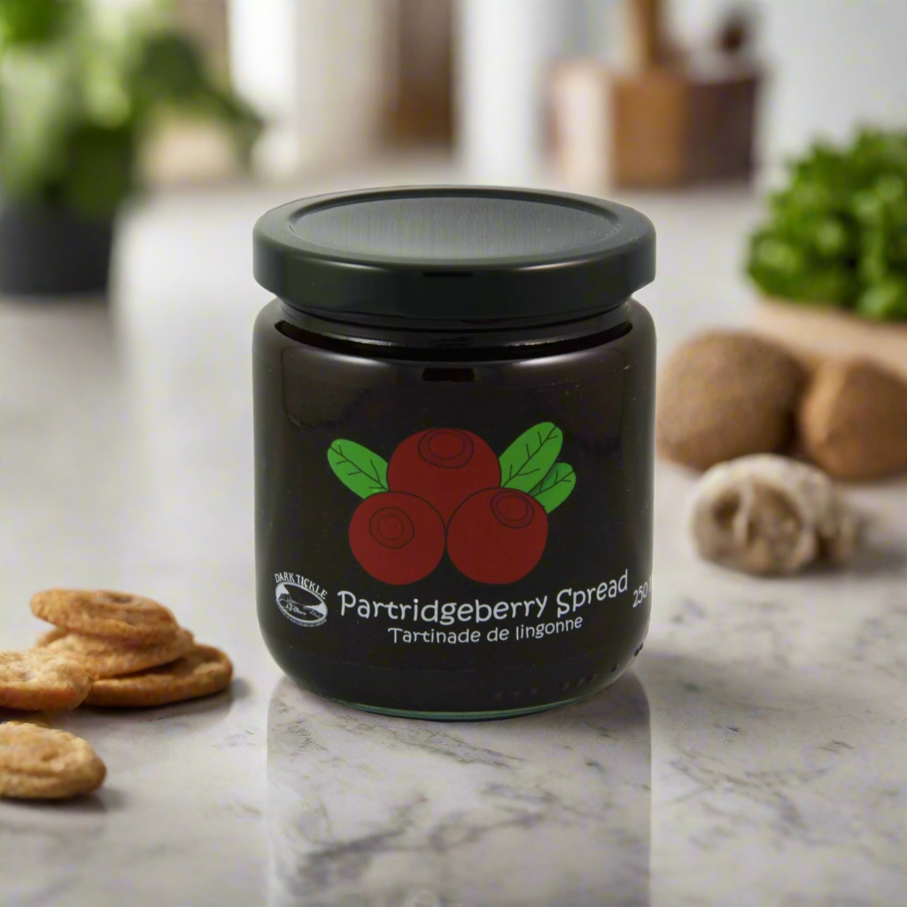 Jar of Old Fashioned Partridgeberry Spread with black lid on a marble countertop.