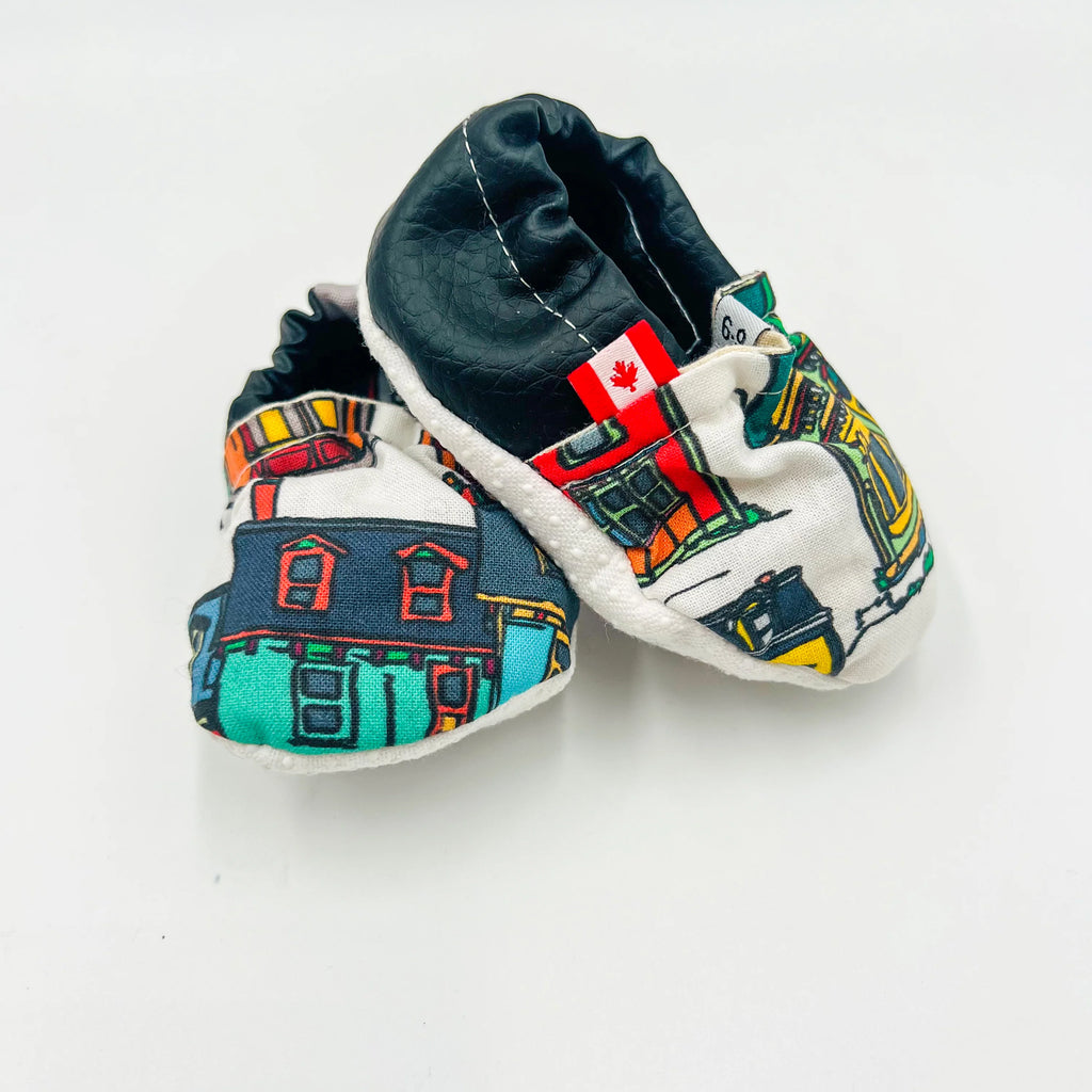 Baby summer shoes with a Canadian flag tag, featuring a vibrant Newfoundland row houses design with white anti-slip soles.