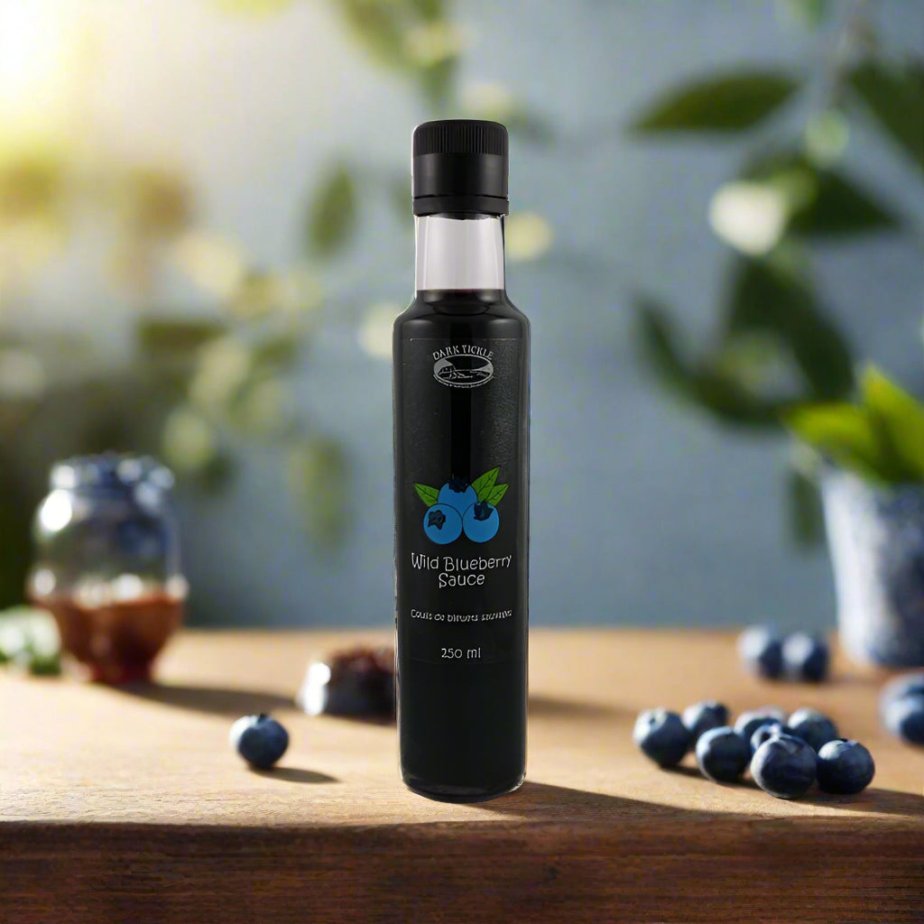 Dark Tickle Wild Blueberry Sauce in a tall, slim 250 ml black bottle with blue berry graphic.